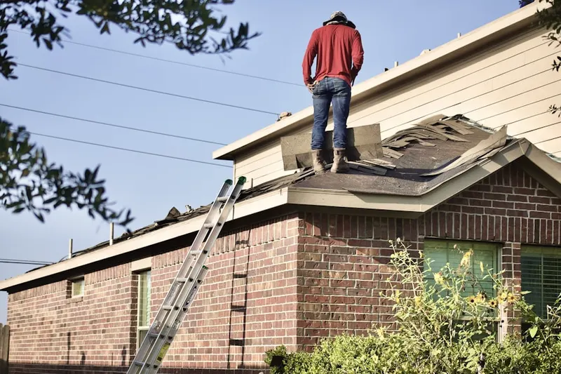 Professional roofer working on a residential roof in Bloomington